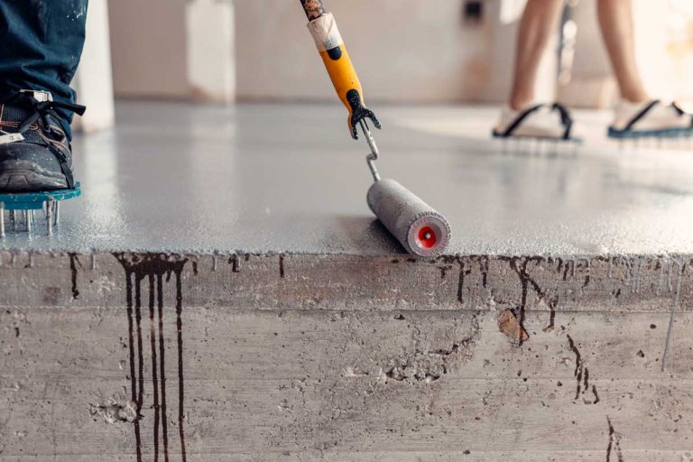 Applying Epoxy To Concrete Floor With Paint Roller